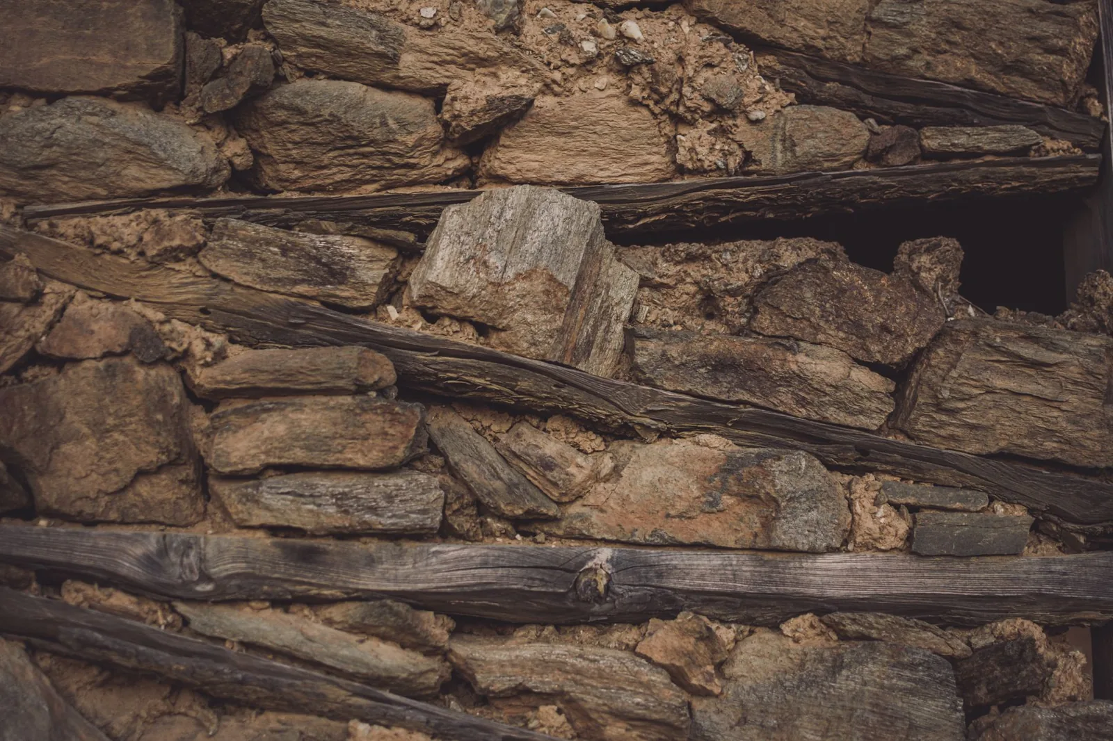 wood vs stone retaining wall cost comparison of a timber wall with gravel backfill