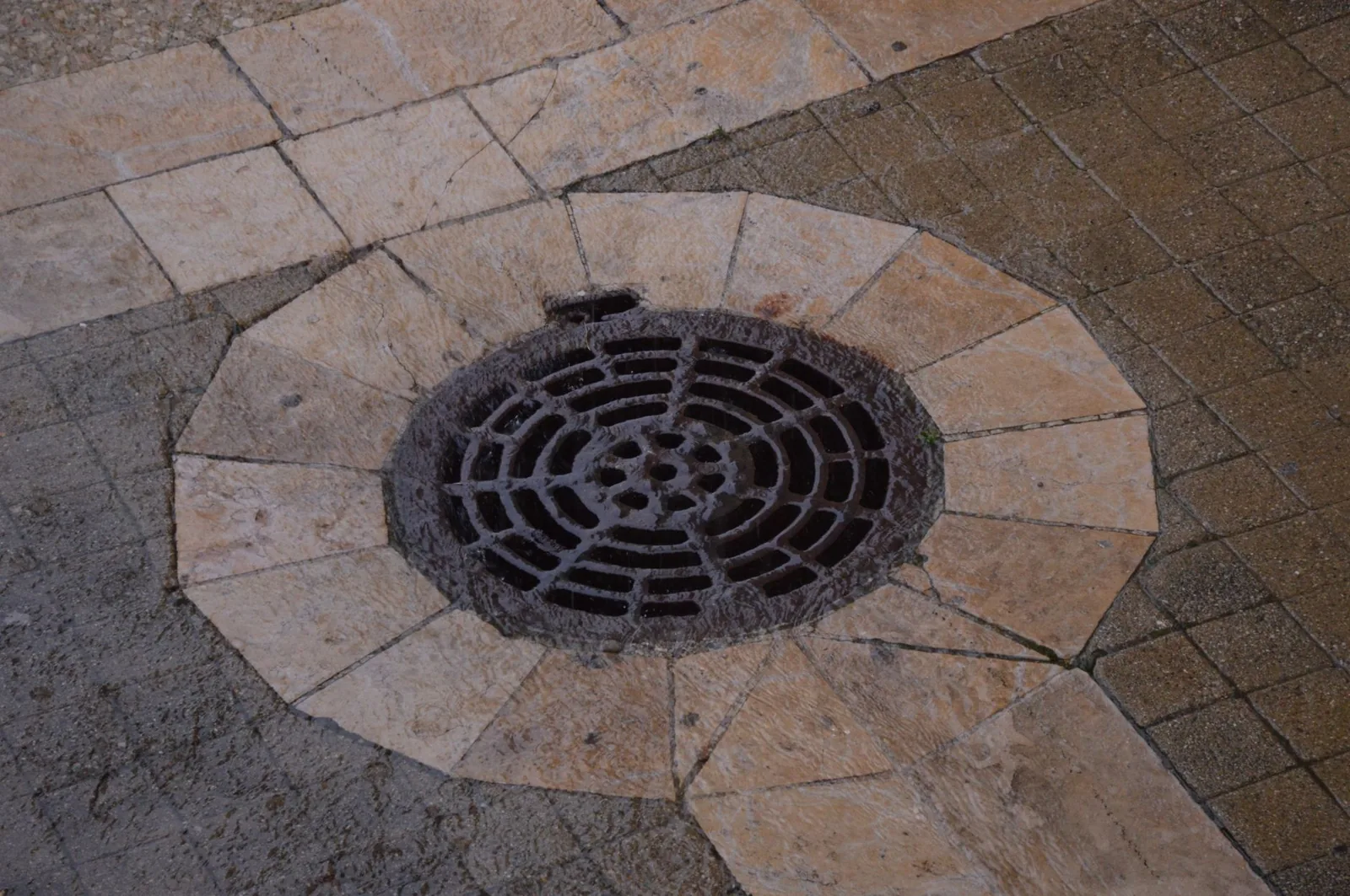 yard drainage cost per foot comparison of French drain and surface channel options