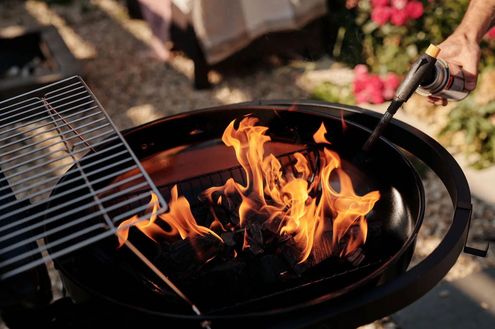 close-up of charcoal glowing in a backyard fire pit
