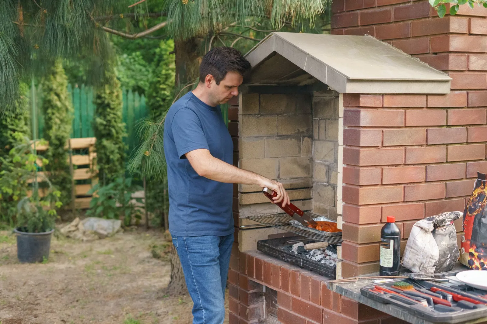 custom outdoor kitchen with stone veneer and built-in grill