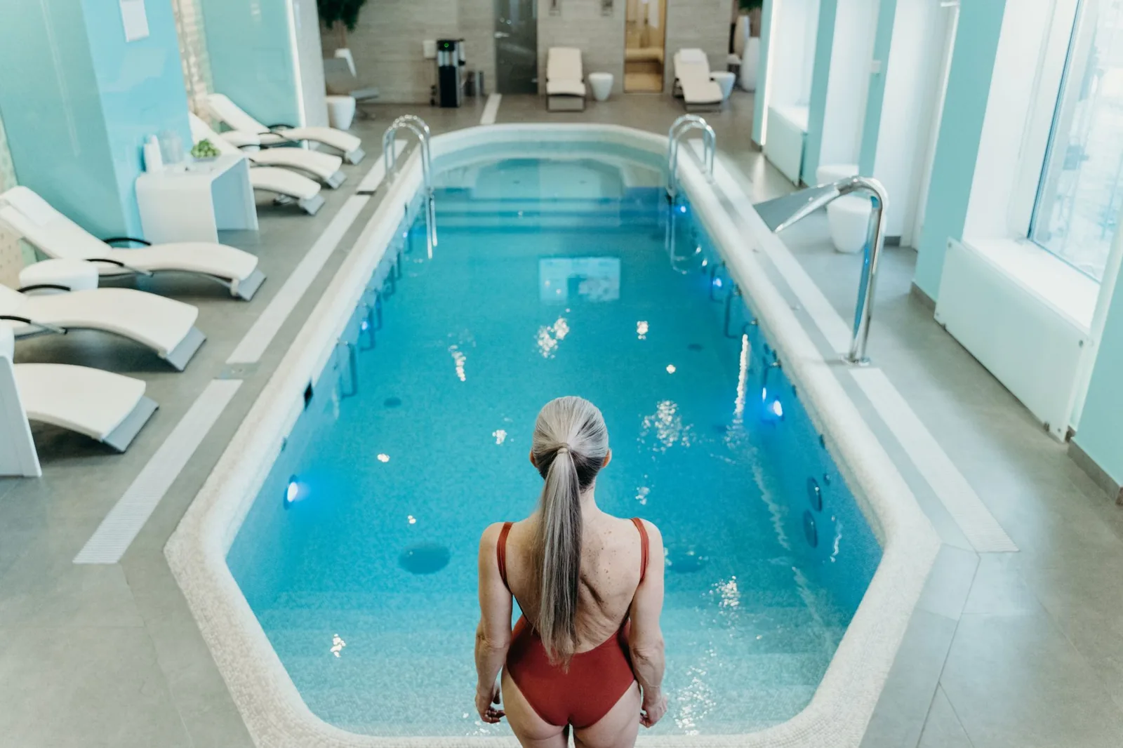 Oval above ground pool with a wooden deck and ladder